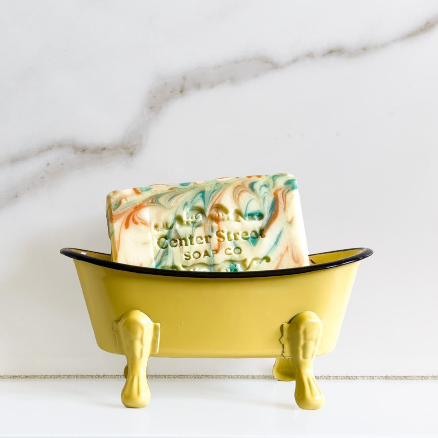 Center Street Soap Co. Orange Grove Handmade Bar Soap in a Yellow clawfoot bathtub soap dish.